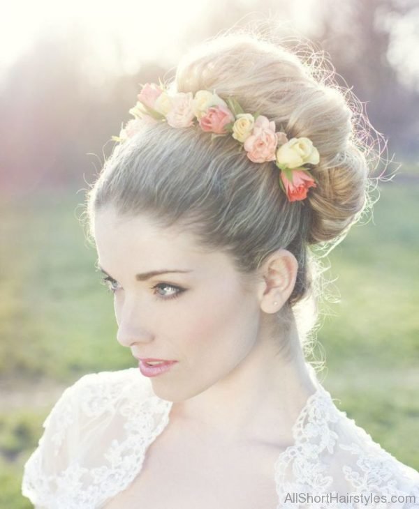 Round Bun Hairstyle With Flowers