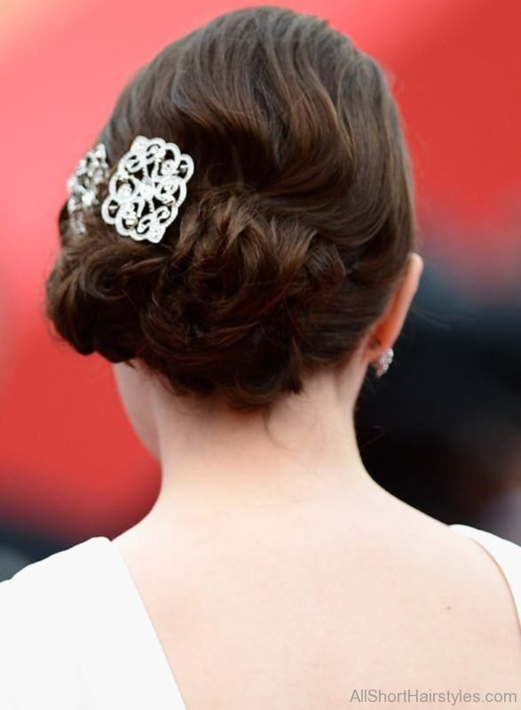 Low Flowery Updo with Textured Waves and Brooch